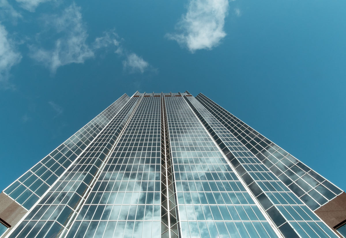 Glass skyscraper facade reflecting the sky