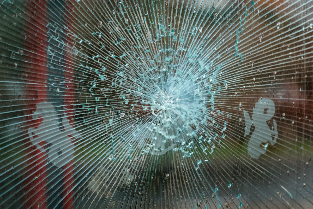 Impact-cracked glass held together in one piece